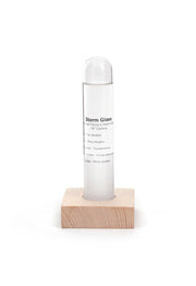 Storm glass is a tube resting inside a square wooden block. Storm glass has details listed on the outside to assist with understanding contents.